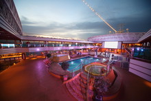 Overview Of Deck Of  Cruise Ship With Screen, Pool And Baths