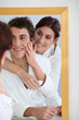 © goodluz - Woman applying moisturizer on boyfriend's cheek