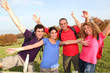 © goodluz - Group of friends hiking in countryside