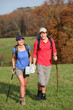 © goodluz - Young couple hiking in countryside