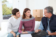 © goodluz - Young couple signing contract for home moving