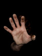 Zombie hand reaching from the dark