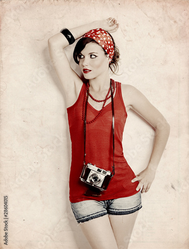 Fototapeta na wymiar Pin-up girl with a camera