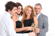 © goodluz - Group of friends cheering with glasses of champagne