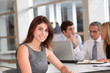 © goodluz - Portrait of beautiful businesswoman in work meeting