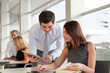 © goodluz - Business people working in the office with agenda