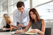 © goodluz - Business people working in the office with agenda