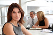 © goodluz - Portrait of beautiful businesswoman in work meeting