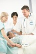 © nyul - Doctors and nurse with older patient