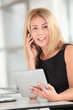 © goodluz - Businesswoman in the office with electronic tab