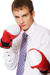 Wall Mural - Young businessaman with boxing gloves