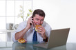© Marco Mayer - man at office with phone eat unhealthy food