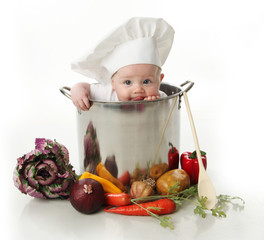 licking baby sitting in a chef's pot