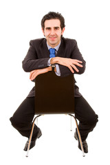 Full body portrait of a young businessman sitting on chair. Isol