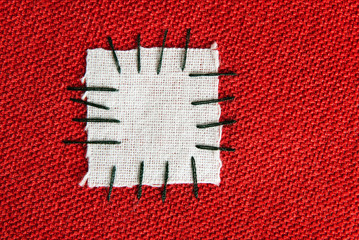 large patch on red cloth - background