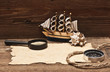 old paper and model classic boat on wood background