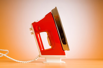 Poster - Modern electric iron against the colorful background