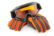 ski goggles and gloves over white background