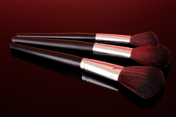 cosmetic brushes on red