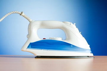 Poster - Modern electric iron against the colorful background