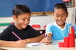 © Darrin Henry - Two schoolboys helping each other learn in class during lessons