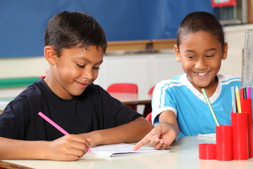 Wall Mural - Two happy school boys sharing learning in class