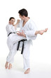 © Aptyp_koK - Karate. Young girl and a men in a kimono with a white background