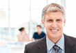 © WavebreakMediaMicro - Businessman looking at the camera while their team is working