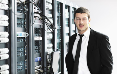 Wall Mural - businessman with laptop in network server room