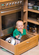 baby playing in drawer