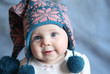 © blessings - Baby with blue eyes in a winter cap