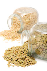 Wall Mural - Glass Jars with Lentils And Brown Rice on White Background