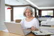 © goodluz - Senior woman doing online shopping at home