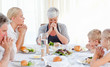 © WavebreakMediaMicro - Pretty family praying at the table