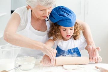 A little girl  baking with her grandmother