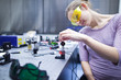 © lightpoet - female scientist doing research in a quantum optics lab (color t