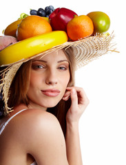 Shot of a beautiful young woman with fruits headwear. Food conce