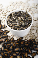 Wall Mural - sunflower seeds on white bowl