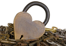 Many Old Keys Isolated With One Brass Locked Heart