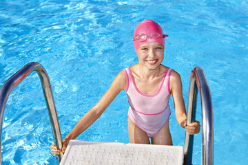 Child swimming in pool.