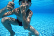 © Pavel Losevsky - Boy dives under water in  pool and closes  nose  hand