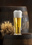 Fototapeta  - glass of beer on old barrel