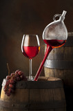 Fototapeta  - glass red wine on old barrel