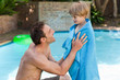 © WavebreakMediaMicro - Father with his son beside the swimming pool