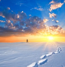 Hiker In A Winter Plain On A Sunset