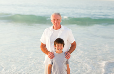 Wall Mural - Grandfather and his grandson at the beach