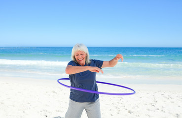 Wall Mural - Senior woman playing with her hoop