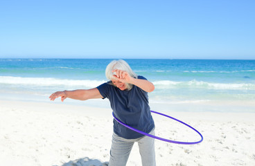 Wall Mural - Senior woman playing with her hoop