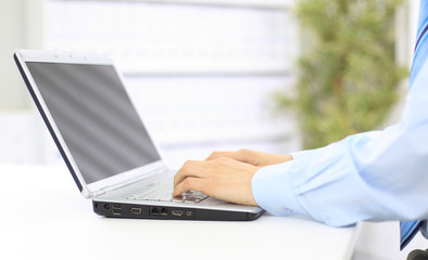 Wall Mural - Person Typing on a modern laptop in an office