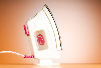 Poster - Modern electric iron against the colorful background